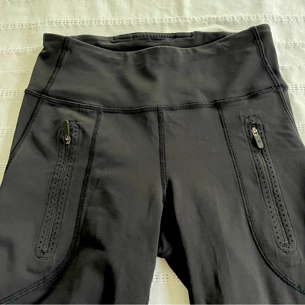 Lululemon black mesh leggings size 4 with mesh design on leg